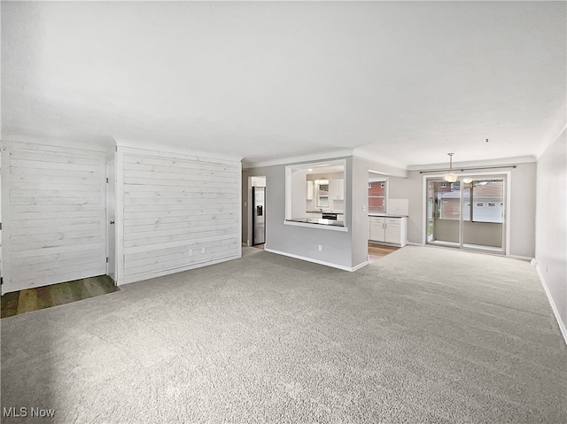 unfurnished living room featuring carpet flooring