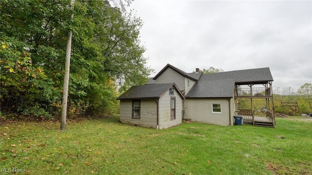 back of house with a lawn