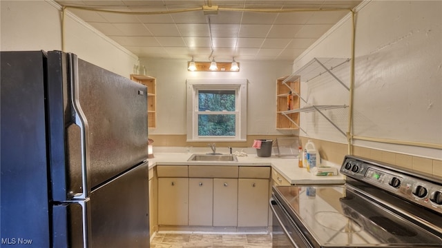 kitchen with electric range oven, fridge, ornamental molding, cream cabinets, and sink