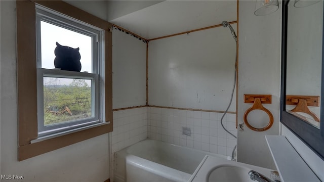 bathroom featuring a healthy amount of sunlight, vanity, and separate shower and tub