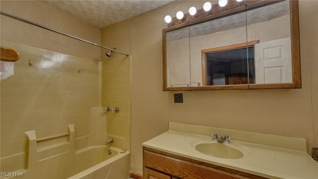 bathroom featuring a textured ceiling, vanity, and shower / bath combination