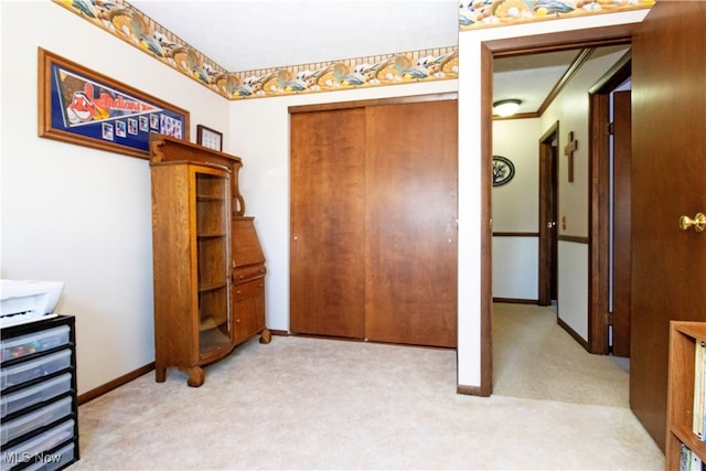 interior space with crown molding and light carpet