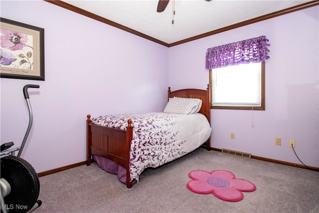 carpeted bedroom with ceiling fan and ornamental molding