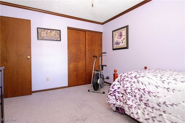 carpeted bedroom featuring a textured ceiling, a closet, and crown molding