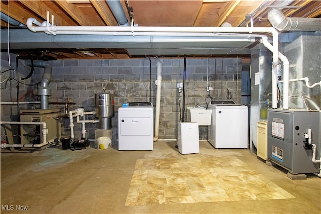 basement with washing machine and clothes dryer and sink