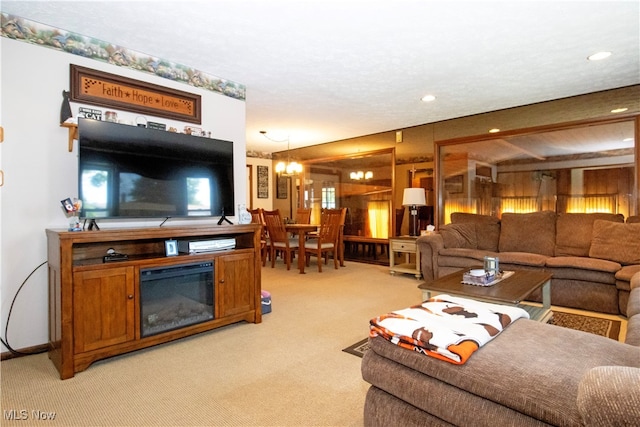 living room with light carpet and a notable chandelier