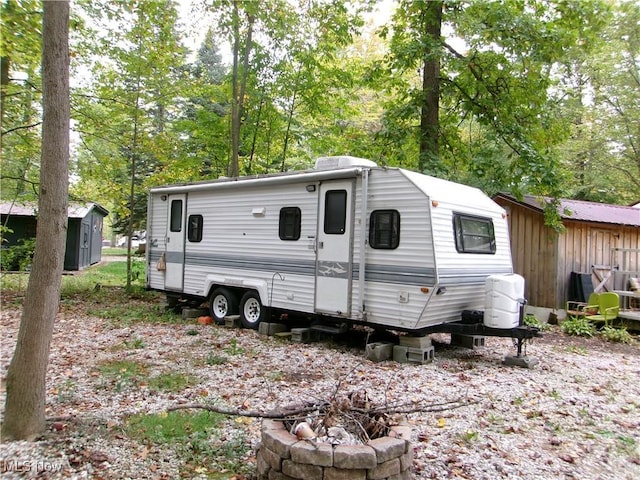 view of outbuilding featuring an outdoor fire pit