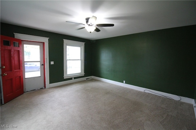 carpeted spare room with ceiling fan