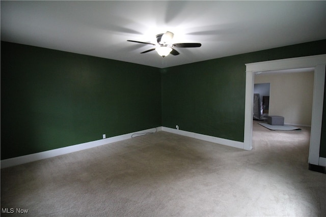 empty room with ceiling fan and carpet flooring