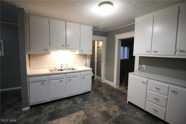 kitchen featuring white cabinetry and sink