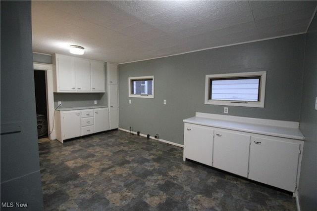 clothes washing area with a textured ceiling