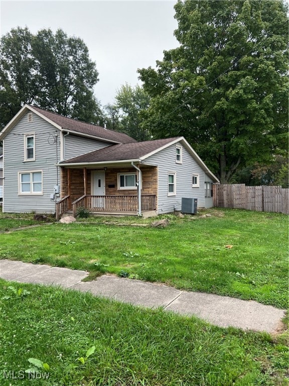 view of front facade with central AC unit, a front yard, and a porch