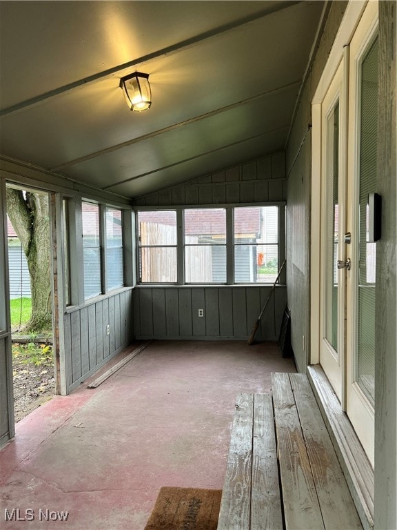 unfurnished sunroom featuring lofted ceiling