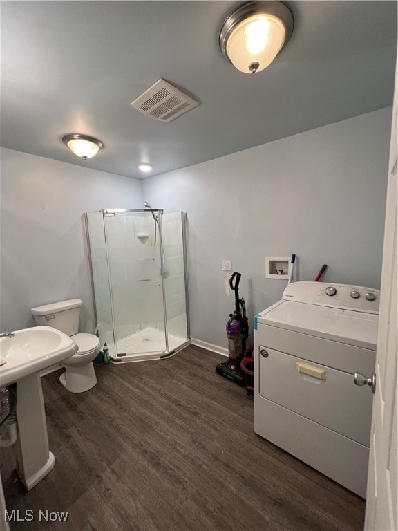 laundry area featuring dark hardwood / wood-style flooring and washer / dryer