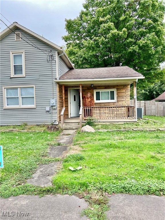 split level home with central air condition unit and a front yard