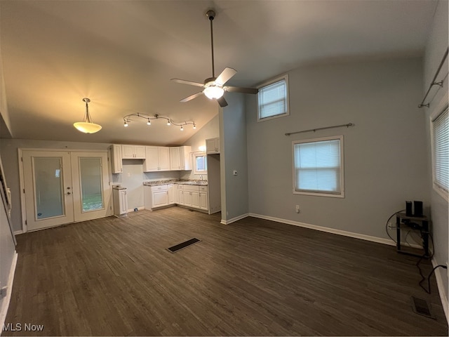 unfurnished living room featuring dark hardwood / wood-style flooring, ceiling fan, sink, and high vaulted ceiling