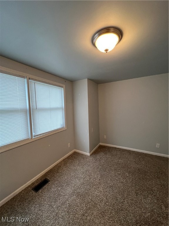 spare room featuring carpet