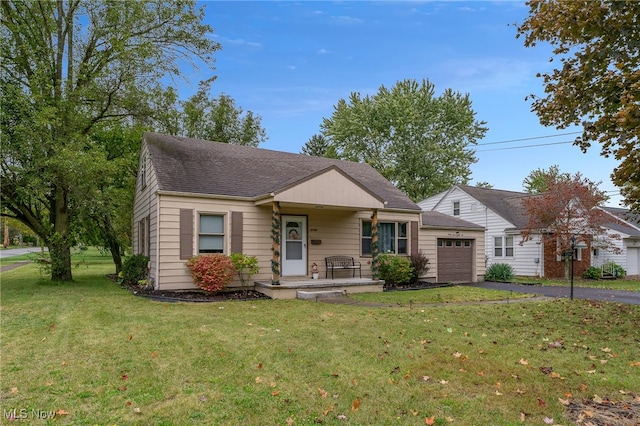 view of front facade with a front yard, a garage, and a porch