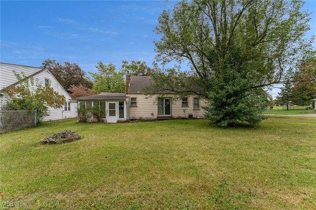 back of house featuring a lawn