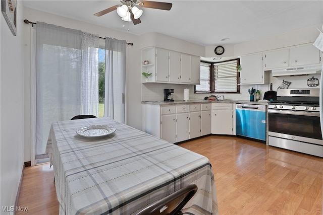 kitchen featuring ceiling fan, appliances with stainless steel finishes, custom range hood, and light hardwood / wood-style flooring