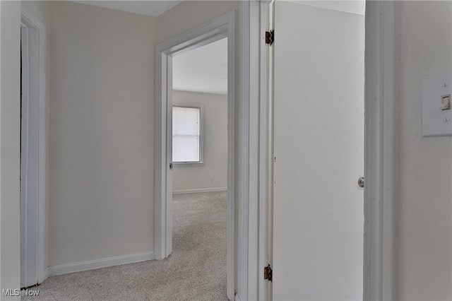 hallway featuring light colored carpet