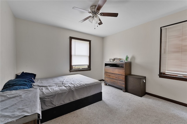 bedroom featuring ceiling fan and light carpet