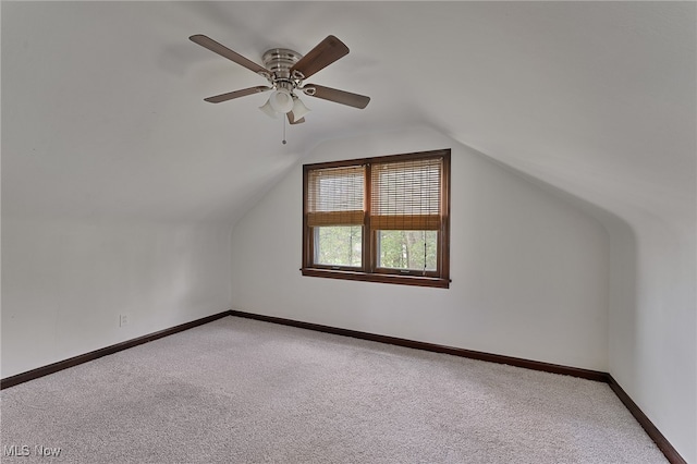 bonus room with vaulted ceiling, ceiling fan, and light colored carpet