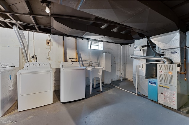 basement with washing machine and dryer and sink