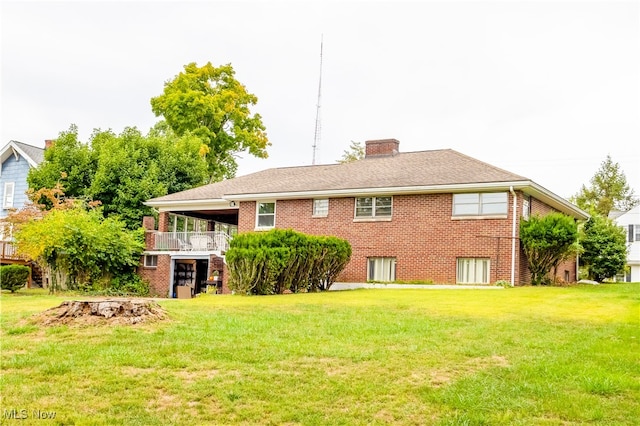 rear view of house with a yard