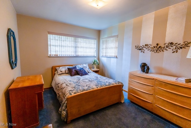 bedroom with dark carpet