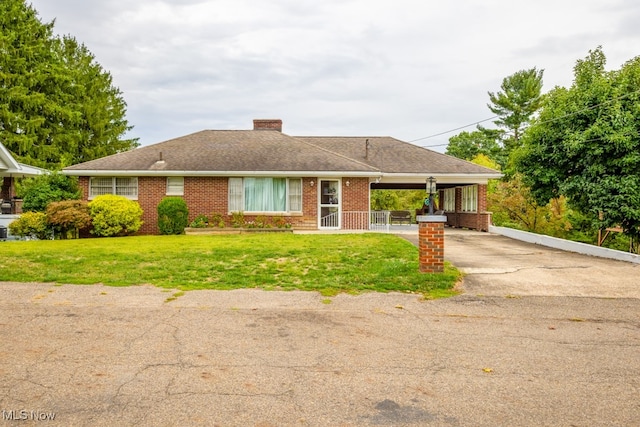 single story home featuring a front lawn and a carport