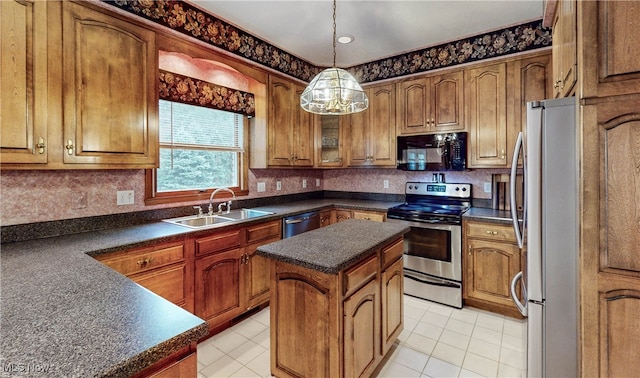 kitchen featuring light tile patterned floors, appliances with stainless steel finishes, sink, and a kitchen island