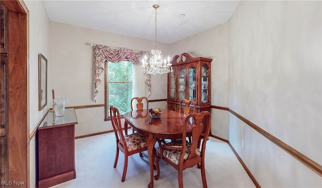 dining area featuring an inviting chandelier and light colored carpet