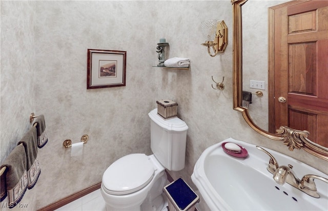 bathroom with sink, toilet, and tile patterned floors