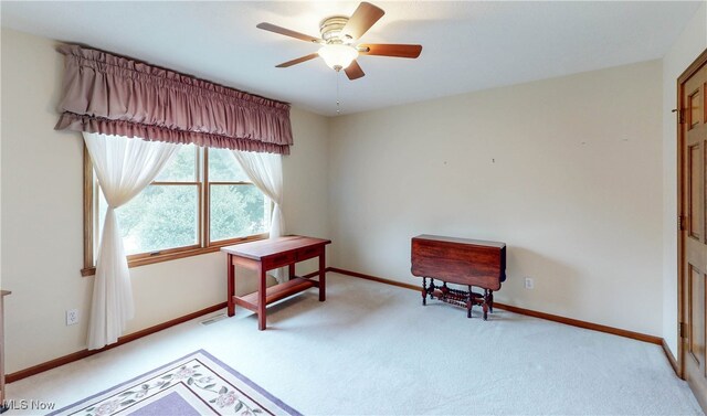 living area featuring ceiling fan and light colored carpet