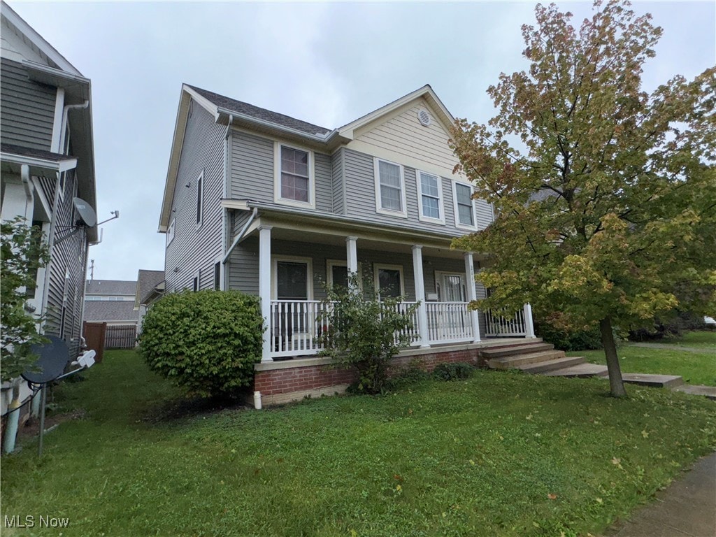 view of front of property with a front yard and a porch