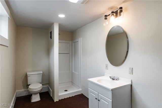 bathroom with toilet, vanity, and a shower