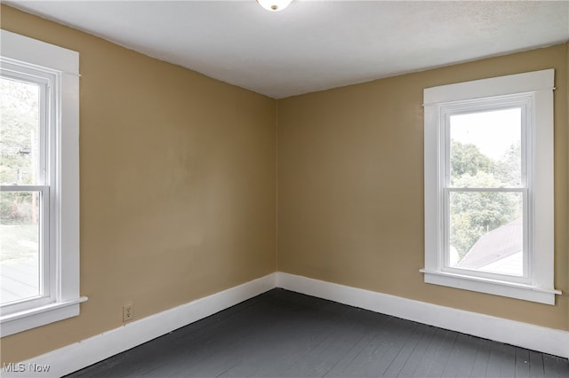 unfurnished room featuring dark wood-type flooring