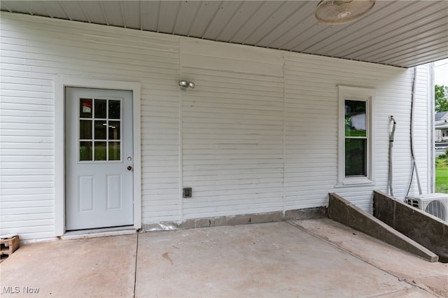 entrance to property featuring ac unit and a patio area