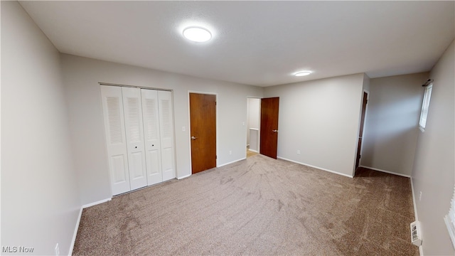 unfurnished bedroom featuring carpet flooring