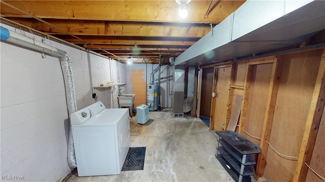 basement featuring washer / clothes dryer, gas water heater, heating unit, and sink