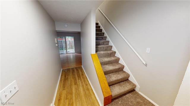 stairway featuring hardwood / wood-style floors