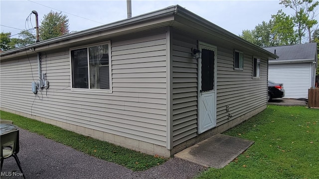 view of side of property with a lawn