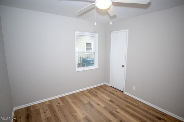 spare room with hardwood / wood-style flooring and ceiling fan