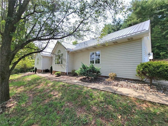 rear view of property featuring a lawn