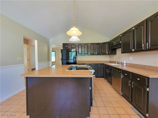 kitchen with hanging light fixtures, dishwasher, lofted ceiling, sink, and black fridge