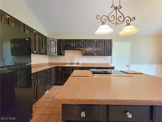 kitchen featuring sink, lofted ceiling, black appliances, backsplash, and decorative light fixtures