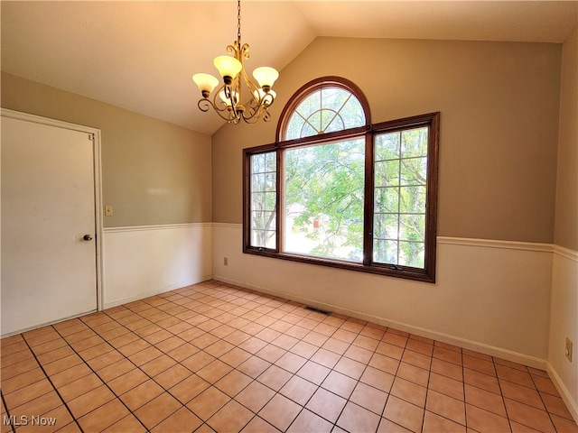 unfurnished room featuring light tile patterned floors, a chandelier, and vaulted ceiling