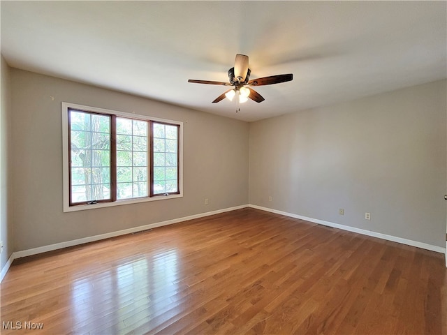 empty room featuring ceiling fan and light wood-type flooring