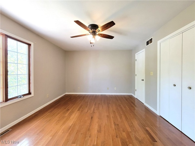 unfurnished bedroom featuring wood-type flooring and ceiling fan